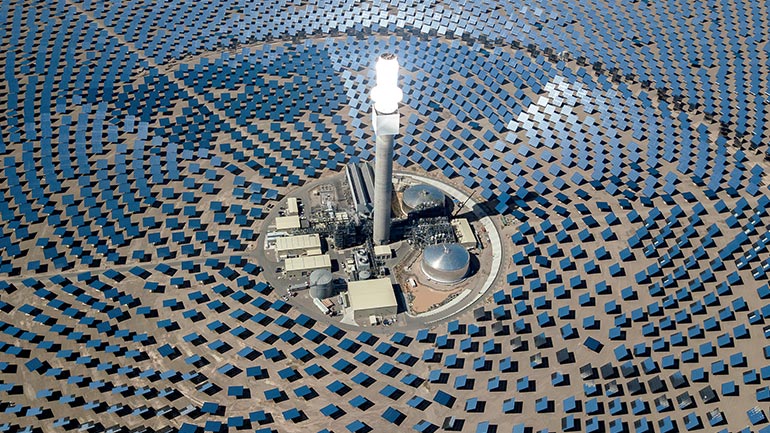Image of a factory surrounded by Solar Panels 