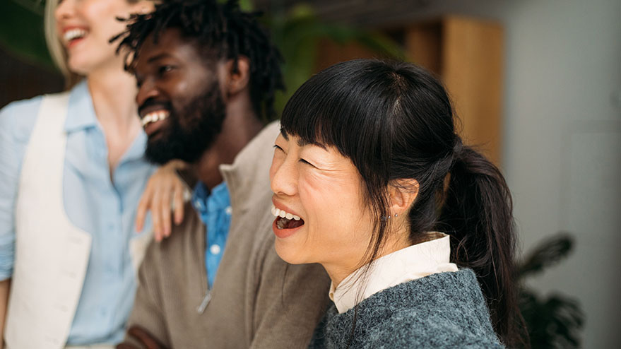 People from diverse ethnic backgrounds collaborating in a workplace setting.