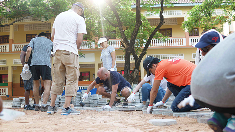 Employees building with concrete bricks 