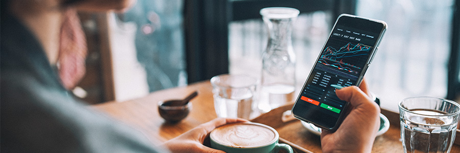 A person looking at financial data on a smartphone screen.