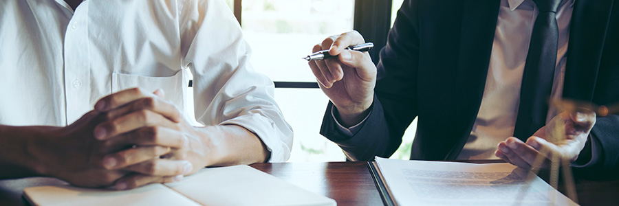 Two people at a table discussing legal issues.