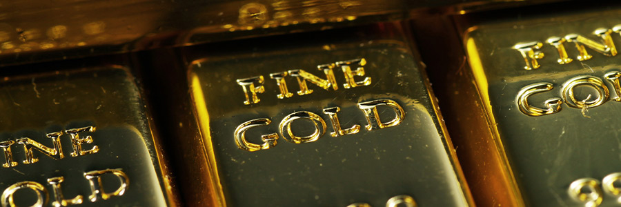 Closeup of multiple gold bars stamped with FINE GOLD 999.9