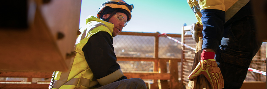 Mining workers handling equipment at a precious metals site