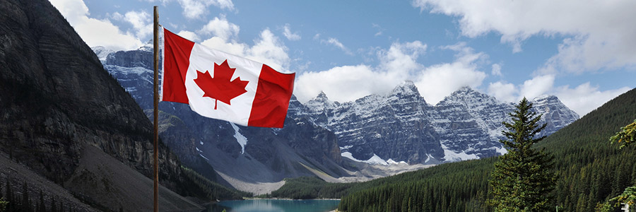 Canadian flag with the Rocky Mountains in the background