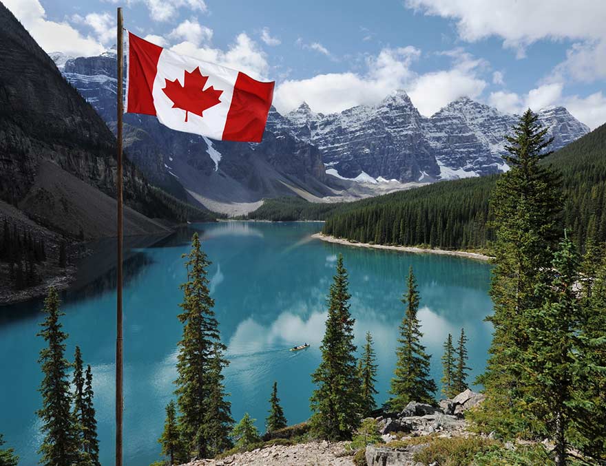 Canadian flag with the Rocky Mountains in the background