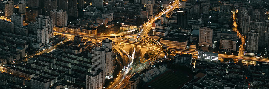 Aerial view of a city highway interchange at night.