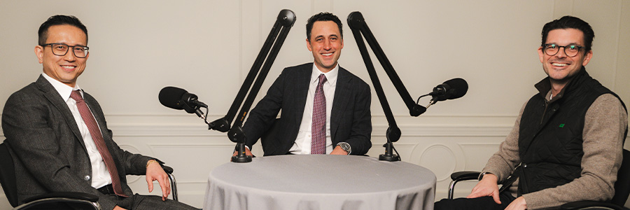 Two professionals discussing work while walking through an industrial facility.