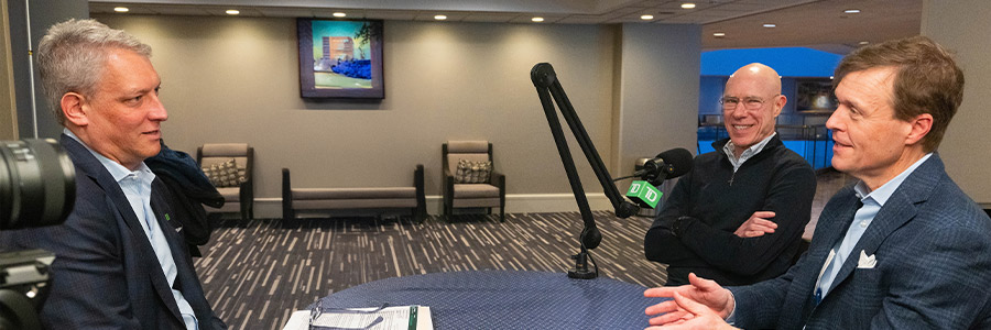 Phil Nadeau, David Meeker and Hunter Smith seated left to right at a roundtable podcast setup with microphones.