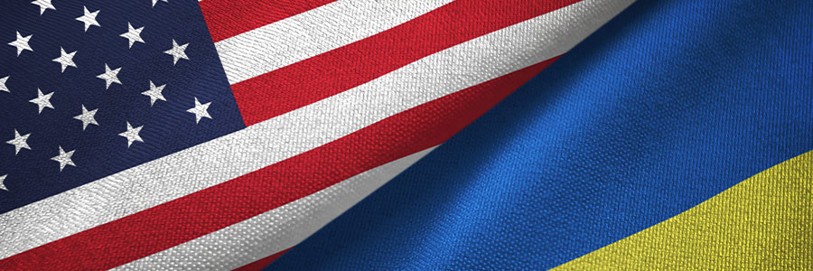 Close up of the American and Ukraine flags overlapping one another.
