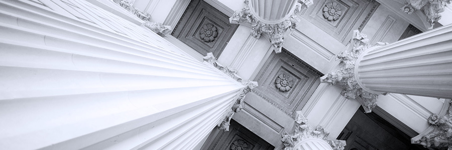 Upward view of large classical stone columns.