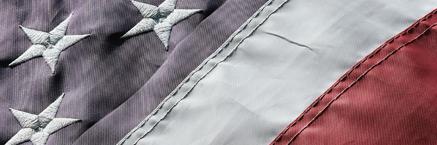 Close-up of the stitched stars and stripes of a United States flag.
