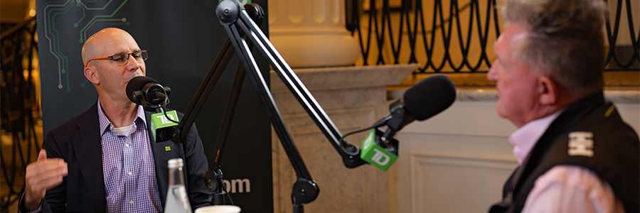 Podcast recording with two speakers using TD-branded microphones at a table