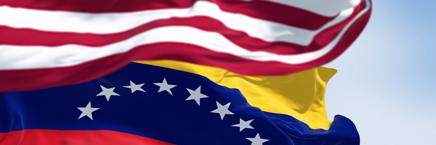 The flag of Venezuela flying behind the United States of America flag.
