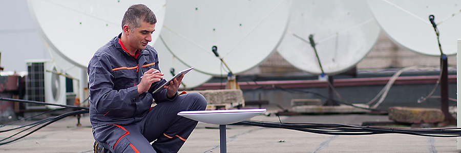 A technician working on satellite communications hardware