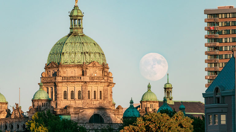 Full moon behind the British Columbia Parliament Buildings in Victoria.