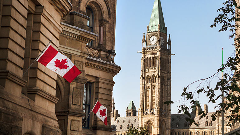Canadian flags beside Parliament’s Peace Tower in Ottawa.