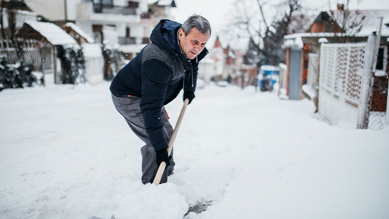 Image of a man shoveling snow