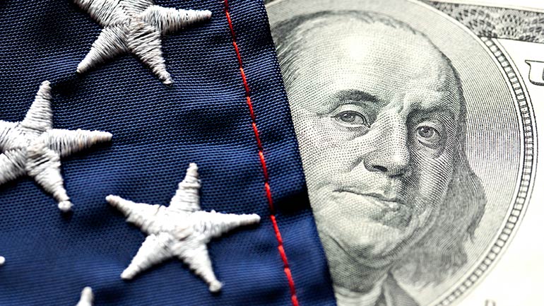 A close-up image of USD currency and the American flag.