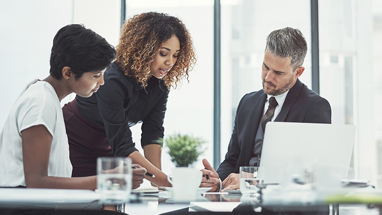 Colleagues consult with each other in a meeting