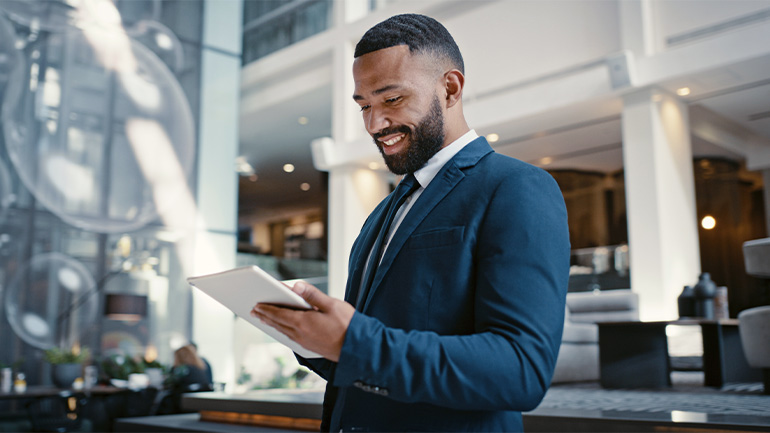 Businessman in an office looking at a tablet computer