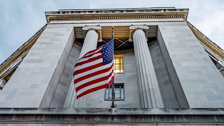 Image of a Marble Building with the U.S. Flag in the Center
