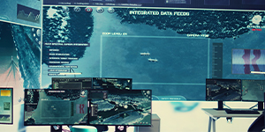 Military control room with screens displaying aerial surveillance data.
